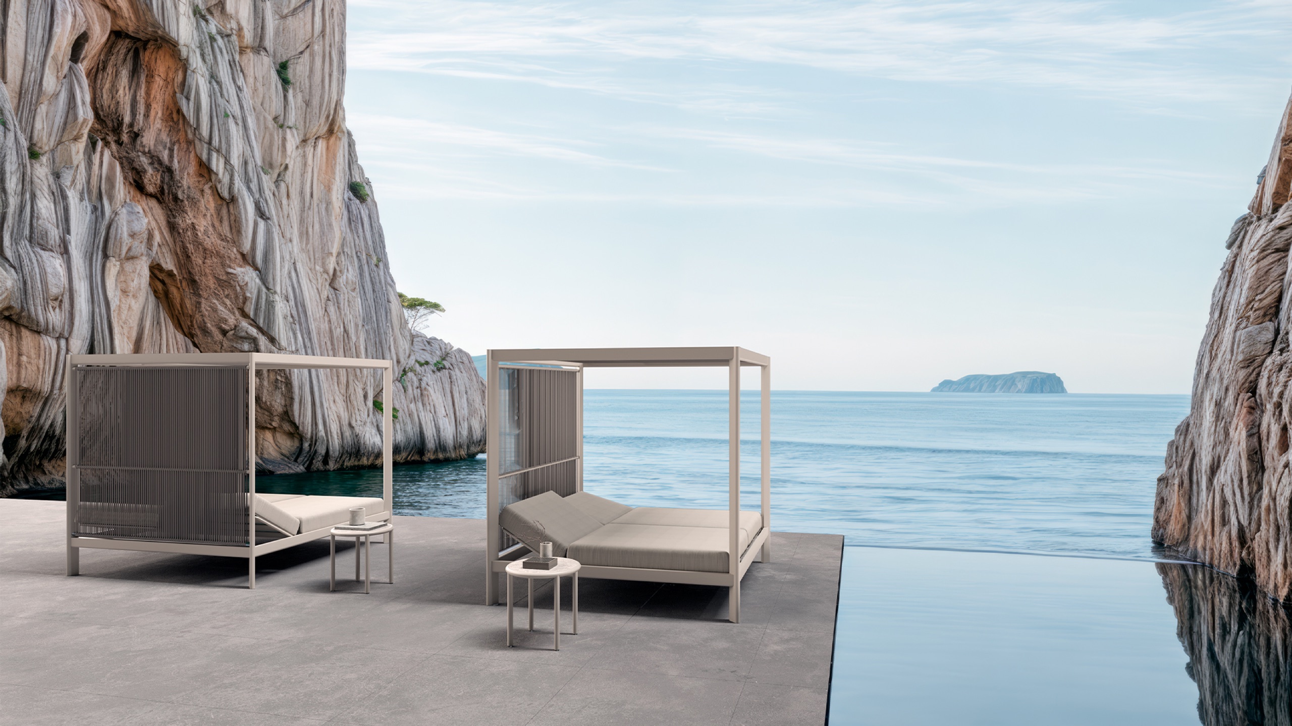 SKLD Studio Tempo canopy daybeds beside an infinity pool overlooking the sea