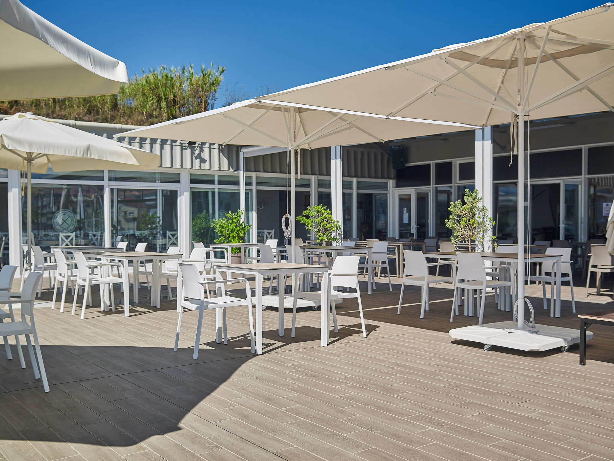 Luxury community pool with a row of white parasols