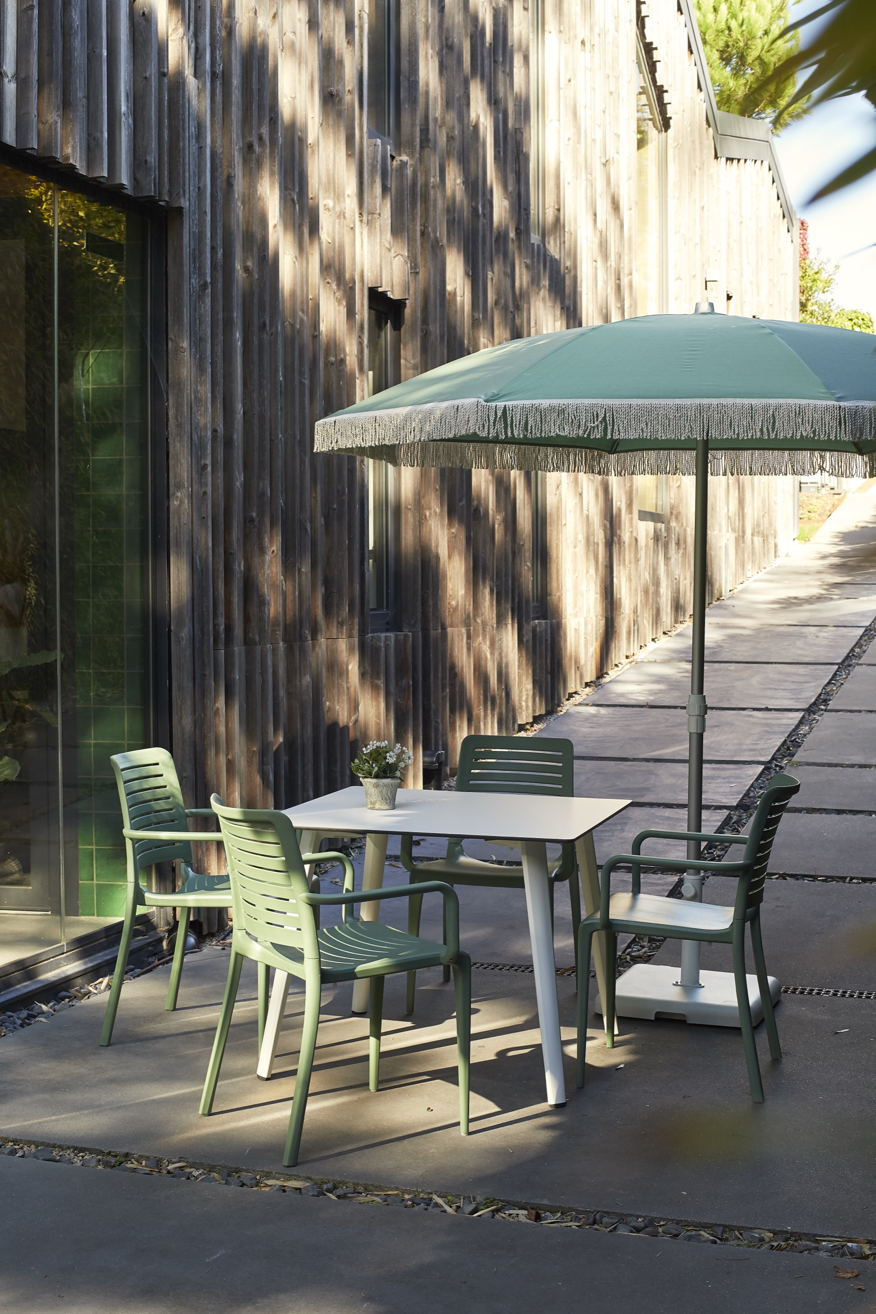 European Ezpeleta parasols shading a poolside seating area
