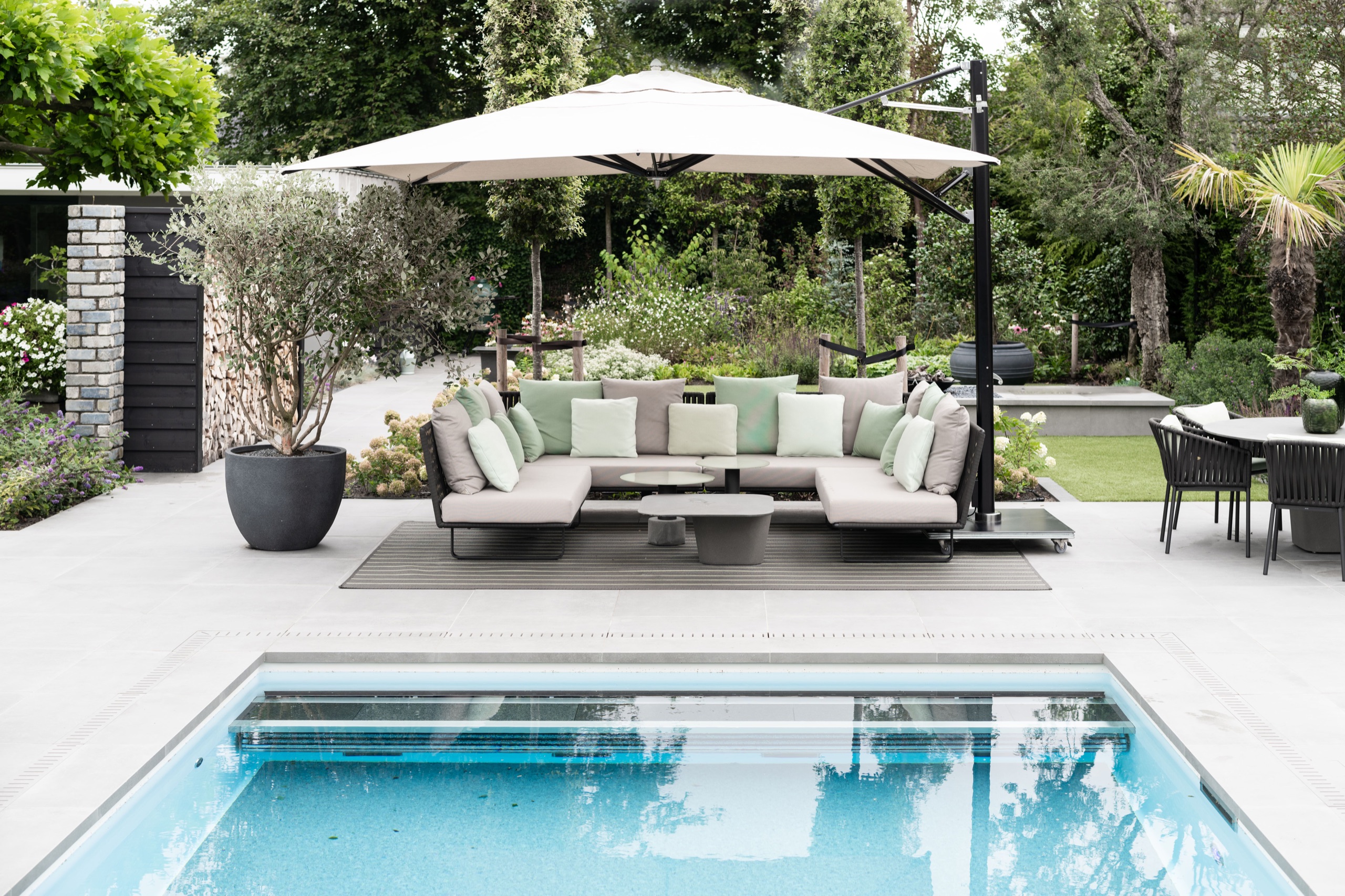 Marine-grade Tuuci cantilever parasol over a pool deck lounge area