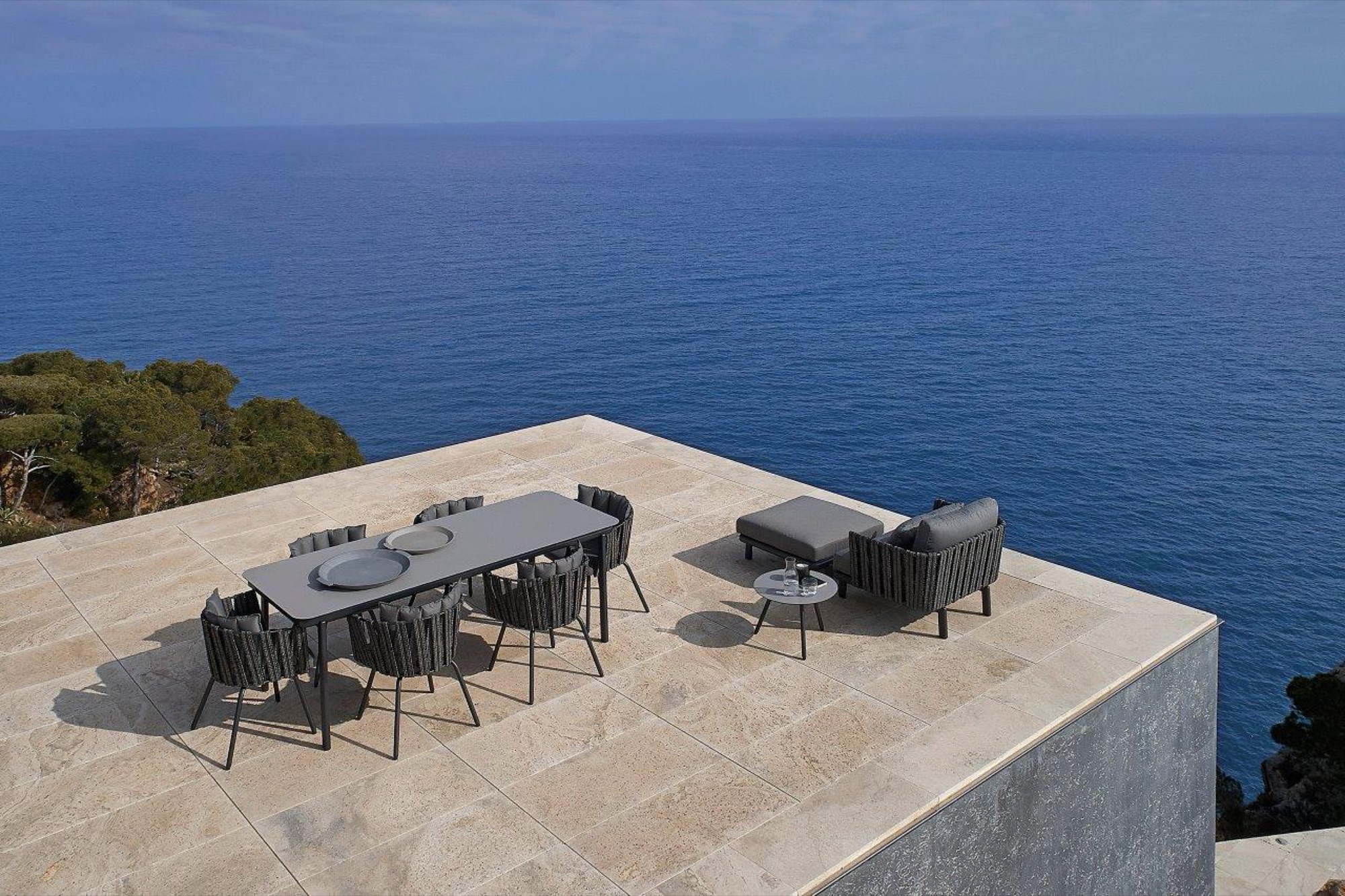 Resol Anthea outdoor dining table and chairs on a clifftop pool terrace